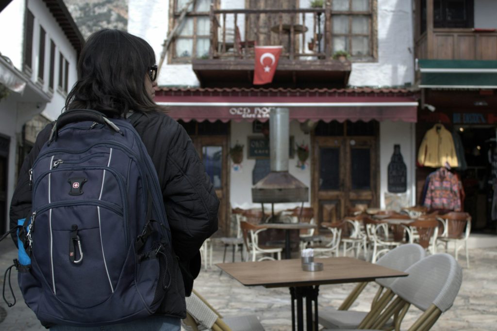 a person with a backpack is standing in front of a building